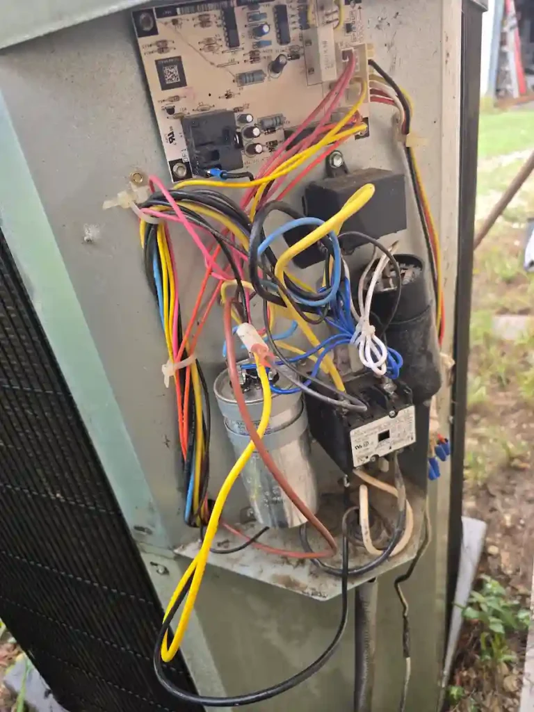 Detailed inspection and cleaning of AC condenser coils during a routine air conditioner check-up in Bexar County