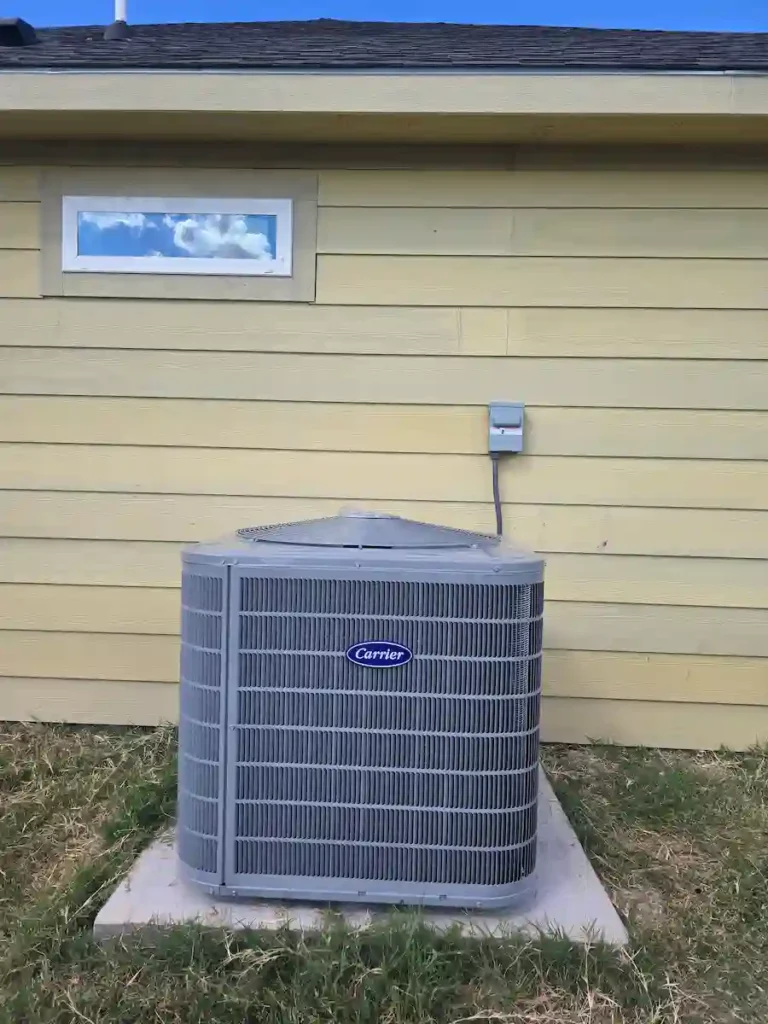 E-MAX HVAC expert inspecting the outdoor unit of a newly installed high-efficiency heat pump system