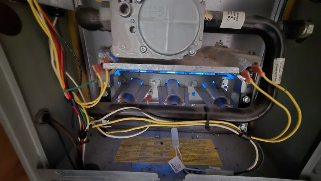 Furnace repair specialist inspecting a gas heating system in a local home